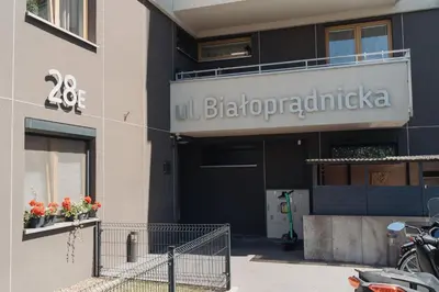 a building with a sign on the side of it at Białoprądnicka - Stay&Park in Kraków