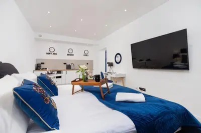 a bedroom with two beds with blue pillows at Studio Cracow Starowiślna by Noclegi Renters in Kraków