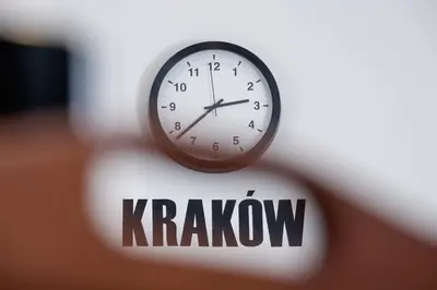 a clock sitting on top of a krakow sign at Studio Cracow Starowiślna by Noclegi Renters in Kraków