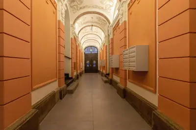 an empty hallway in a building with orange walls at Studio Cracow Starowiślna by Noclegi Renters in Kraków