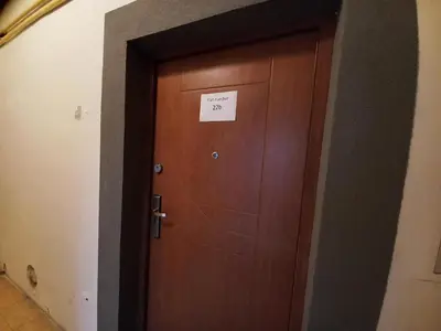 a wooden door with a sign on it at Old Town Apt - Lubicz 2b in Kraków