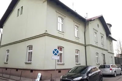 a white building with cars parked in front of it at Old Town Apt - Lubicz 2b in Kraków