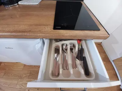a table with knives and utensils in a drawer at Old Town Apt - Lubicz 2b in Kraków