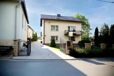 a house with a gate on the side of a street at Jurajska47 in Wola Kalinowska