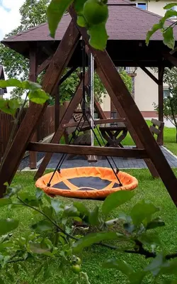 an orange kayak on a swing in a park at Jurajska47 in Wola Kalinowska