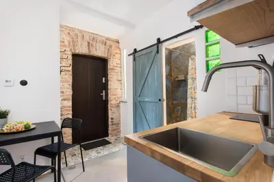 a kitchen with a sink and a table with chairs at Carlson near Enerdgylandia in Zator