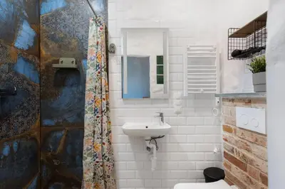 a bathroom with a sink and a toilet and a mirror at Carlson near Enerdgylandia in Zator