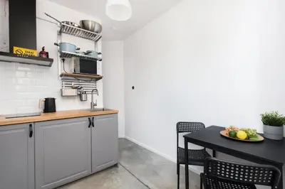 a kitchen with a table with a plate of fruit at Carlson near Enerdgylandia in Zator
