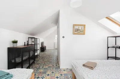 a white room with two beds and a white wall at Carlson near Enerdgylandia in Zator