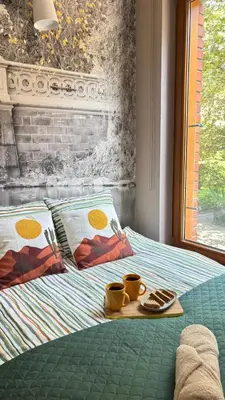 a tray with two cups on a bed at Cozy Mood Apartment Cracow in Kraków