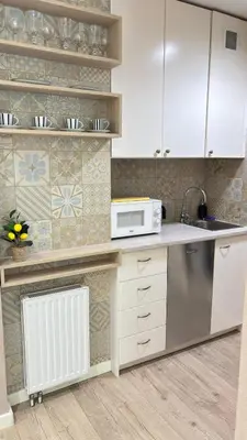 a kitchen with a sink and a microwave at Cozy Mood Apartment Cracow in Kraków