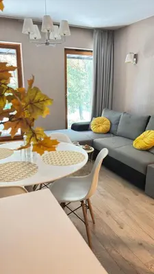 a living room with a couch and a table and chairs at Cozy Mood Apartment Cracow in Kraków
