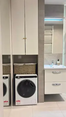a kitchen with a washing machine and a sink at Cozy Mood Apartment Cracow in Kraków