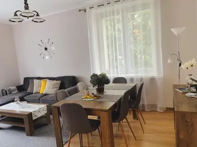 a living room with a table and a couch at Apartament Marysia in Oświęcim