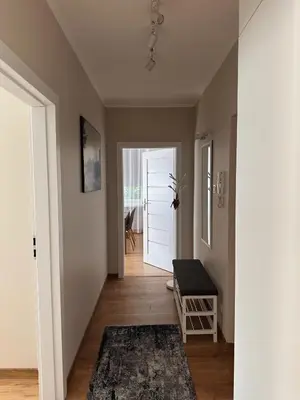 a room with a hallway with a door and a rug at Apartament Marysia in Oświęcim