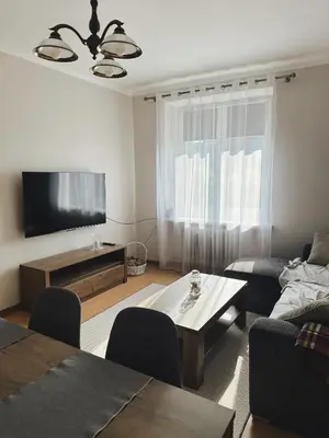 a living room with a couch and a tv at Apartament Marysia in Oświęcim