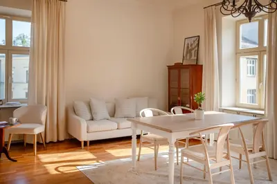 a living room with a table and a couch at Wolnica No 11 Residence in Kraków