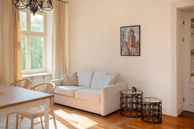 a living room with a white couch and a table at Wolnica No 11 Residence in Kraków