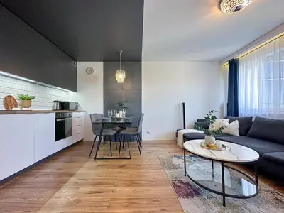 a living room with a couch and a table at Krakowska Konstelacja Apartament premium in Kraków