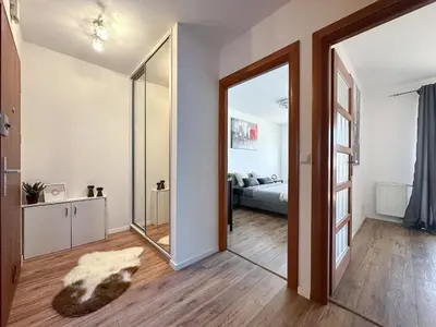 a living room with a mirror and a bed at Krakowska Konstelacja Apartament premium in Kraków