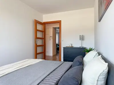 a bedroom with a bed and a blue dresser at Krakowska Konstelacja Apartament premium in Kraków