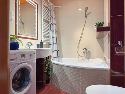 a bathroom with a washing machine and a sink at Krakowska Konstelacja Apartament premium in Kraków