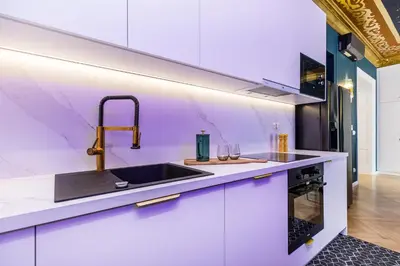 a kitchen with white cabinets and a sink at BoB Elite - Floriańska in Kraków