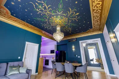 a dining room with a ceiling with a chandelier at BoB Elite - Floriańska in Kraków