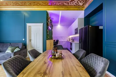 a dining room with a wooden table and purple ceilings at BoB Elite - Floriańska in Kraków