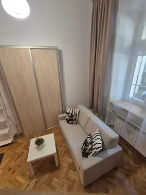 a living room with a couch and a table at Silent Garncarska Apartment in Kraków