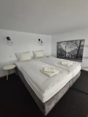 a large white bed with two pillows on it at Silent Garncarska Apartment in Kraków