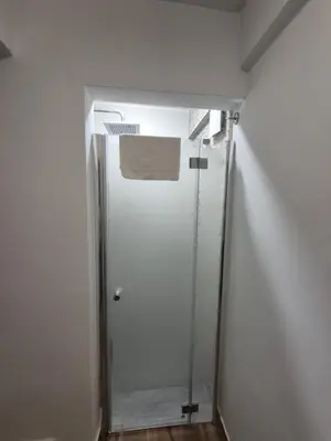 a hallway with a glass door in a room at Silent Garncarska Apartment in Kraków