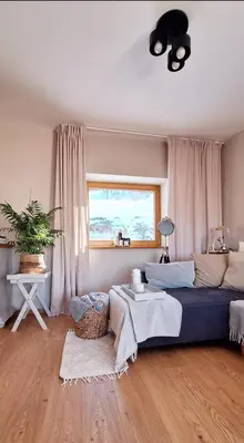 a living room with a bed and a window at Spokojnia Dom Wiejski in Zawoja