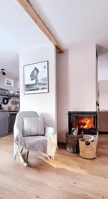 a living room with a couch and a fireplace at Spokojnia Dom Wiejski in Zawoja