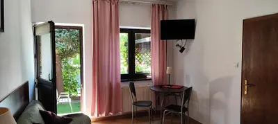 a living room with a table and a window at Za Rabą Nowy in Myślenice