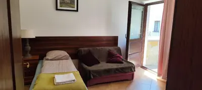 a room with a chair and a bed and a window at Za Rabą Nowy in Myślenice