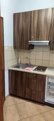 a kitchen with wooden cabinets and a sink at Za Rabą Nowy in Myślenice