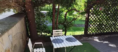a table and two chairs sitting next to a fence at Za Rabą Nowy in Myślenice
