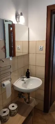 a bathroom with a white sink and a mirror at Za Rabą Nowy in Myślenice
