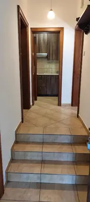 a hallway with stairs leading to a kitchen at Za Rabą Nowy in Myślenice