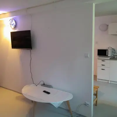 a room with a table and a tv on a wall at Domek Krukk blisko Energylandii Zator in Zator