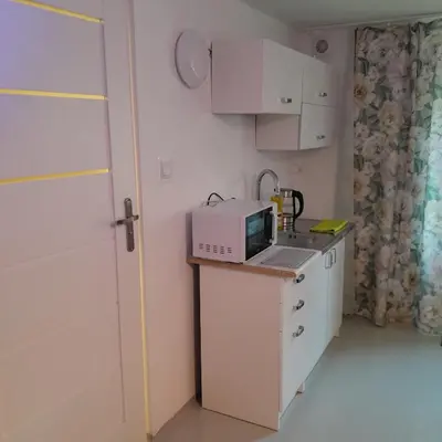 a small kitchen with a microwave on a counter at Domek Krukk blisko Energylandii Zator in Zator
