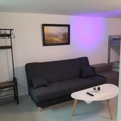 a living room with a couch and a table at Domek Krukk blisko Energylandii Zator in Zator