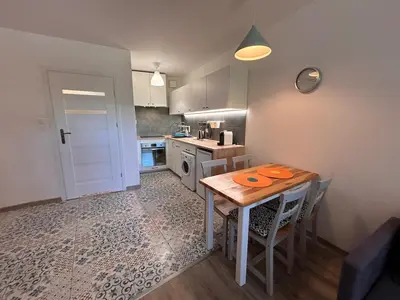 a kitchen with a table and chairs in a room at Old Town Apt Kącik Street K10 in Kraków