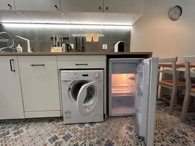 a kitchen with a washing machine in a kitchen at Old Town Apt Kącik Street K10 in Kraków