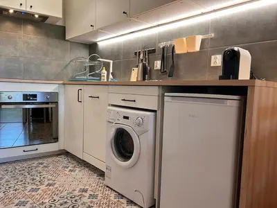 a kitchen with a washing machine and a sink at Old Town Apt Kącik Street K10 in Kraków