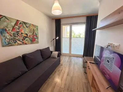 a living room with a couch and a tv at Old Town Apt Kącik Street K10 in Kraków