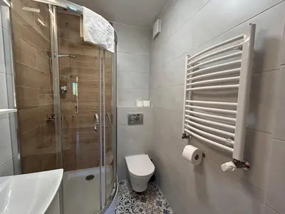 a bathroom with a shower and a toilet and a sink at Old Town Apt Kącik Street K10 in Kraków