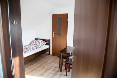 a small bedroom with a bed and a table at Jurajska47 - trójka in Wola Kalinowska
