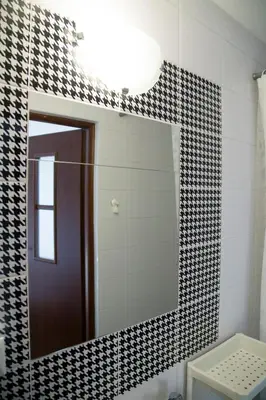 a mirror in a bathroom with black and white tiles at Jurajska47 - trójka in Wola Kalinowska